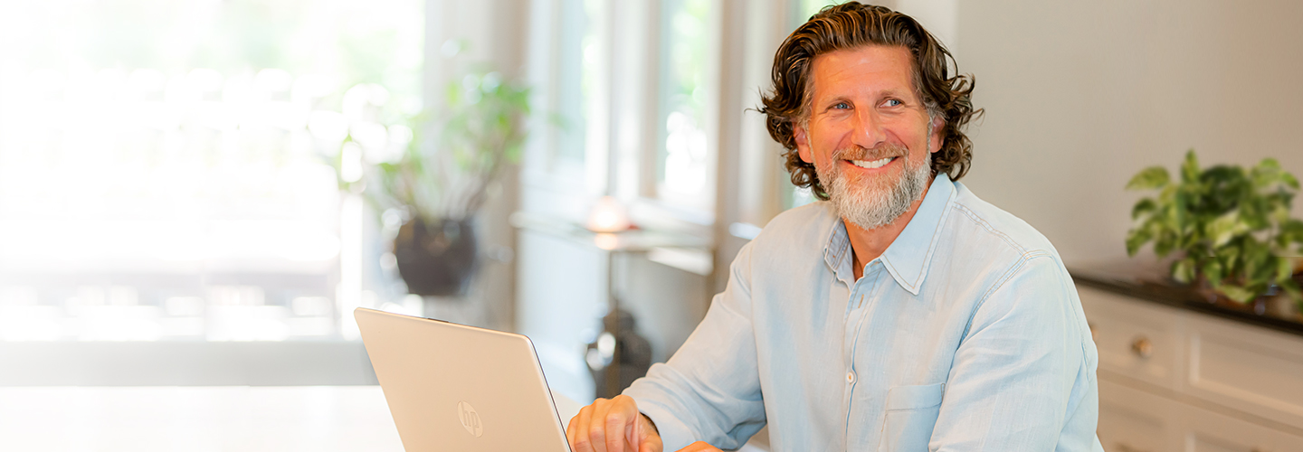 Mark Williams working on laptop at home